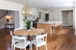 © Raymond Forbes LLC/Stocksy - Home kitchen table  with modern home decor and island