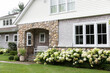 © Raymond Forbes LLC/Stocksy - Front Door Exterior Facade Contemporary Home in Summer hydrangea