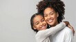 Loving family moment between mother and daughter with a tight embrace. Joyful young girl hugging her older sister showing affection and happiness. Warm and happy siblings share a tender hug and smiles