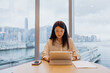 © Heng Yu/Stocksy - Businesswoman Working on Tablet.