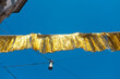 © Colour Laboratory/Stocksy - Golden shiny festival party ribbon and clear blue sky