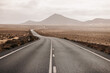 © Nibuya Qubik/Stocksy - Empty lonely road in desert with sunny and cloudy sky