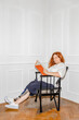 © Dima Sikorski/Stocksy - A disabled woman with a prosthetic leg reads a book in a bright room