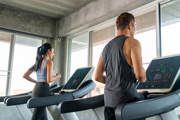 Wall Mural - Group of Healthy Asian man and woman athlete in sportswear jogging workout exercise on treadmill at fitness gym. Wellness people do sport training cardio workout on running machine at sport club.