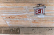 © David Keller/Stocksy - An old exit sign seen mounted to the ceiling