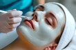 Face peeling mask,spa beauty treatment,skincare.Woman getting facial care by beautician at spa salon