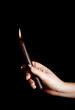© Lindsey Rivera/Stocksy - Black Candlestick with Flame