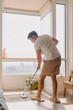 © Sevendeman - Asian Thai man using mop for cleaning floor in living room apartment, Man do household chores, housework concept. marriage life.