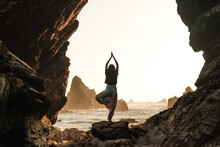 Silhouette Of Woman Doing Yoga In Nature