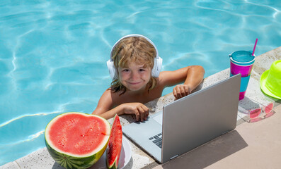 Poster - Child with laptop in swimming pool in summer day. Work outside concept, Business and summer.