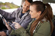 Road trip, couple or tablet for navigation in car, adventure or connectivity for travel exploration in nature. People, technology or bonding together on holiday, journey or care on honeymoon in oman