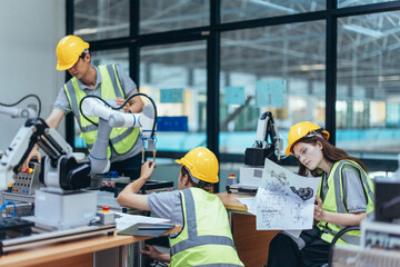 Wall Mural - trainees programing robotic arm in practical lesson at robotics academy, focusing on hands-on skills