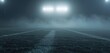 Empty Football Field Shrouded in Mist Under Lights