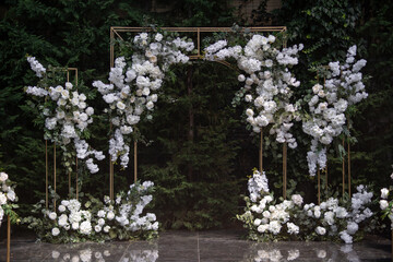 Wall Mural - Wedding ceremony. Very beautiful and stylish wedding arch, decorated with various fresh flowers, standing in the garden.