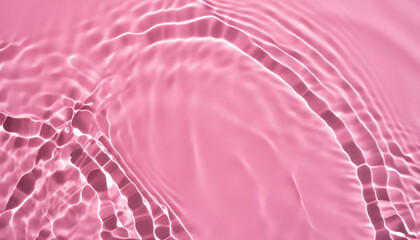 Wall Mural - Abstract transparent water shadow surface texture natural ripple on pink background; creative stock photo image banner