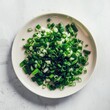 Chopped green onions on a white table