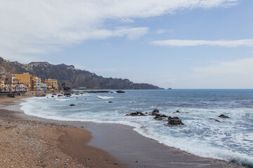 Wall Mural - Ionian Sea shore in Giardini Naxos in the Metropolitan City of Messina on the island of Sicily, Italy