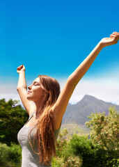 Summer, woman and freedom in forest with peace, green trees and relax for wellness. Environment, satisfaction and female person at countryside garden with nature, sunshine and blue sky in park