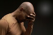 © herlanzer - men in pain with headache praying to God in desperation with people stock image stock photo