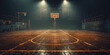An empty basketball court with a spotlight shining on the hoop, banner