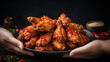 Koreanstyle spicy deep fried chicken wings being held
