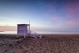 Fototapeta Boho - Lifeguard tower on the empty beach at sunrise  in Puerto del Carmen, Lanzarote