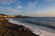 Evening tide on the beach in Aberystwyth at sunset.