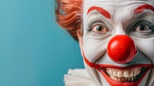 A Close-up Of A Clown's Face With A Big Red Nose And A Wide Smile