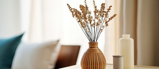 Wall Mural - A wooden table is adorned with a glass vase and a bottle standing upright. The vase contains fresh flowers while the bottle appears to be empty. The setting is simple and uncluttered.