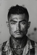 Portrait of an Asian man in tattoos from the Yakuza mafia. Old vintage retro black and white film photography. Mugshot of arrested criminal