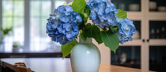 Wall Mural - A white vase filled with blue hydrangeas rests on a wooden table in a cozy home in Sweden. The vibrant flowers contrast beautifully against the clean white vase.