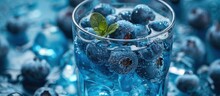 A glass filled to the brim with fresh blueberries and ice cubes, creating a cool and refreshing beverage.