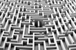 A man standing in the middle of a maze. Suitable for concept of confusion or problem-solving
