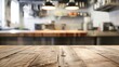 Wooden tabletop with free space for product display against white kitchen with cutting board and plant in scandinavian style in morning light