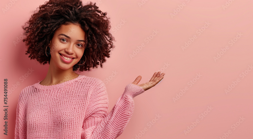 Portrait of a beautiful young woman smiling and holding out her palm on ...