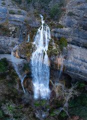 Wall Mural - La Mea waterfall seen from a drone. Between Quintanilla Valdebodres and Puentedey in the area of the Canales del Dulla. The Merindades. Burgos. Castile and Leon. Spain. Europe