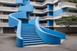 Blue modern architecture with curved staircase and tree