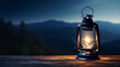 A glowing lantern on a wooden table with a blurred mountain landscape and dark blue night sky in the background.