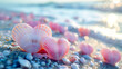 Two pink heart-shaped seashells on the seashore at the sunset