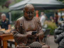 A Statue Of A Buddha Statue Is Looking At A Cell Phone. Generative AI.
