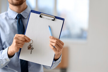 Poster - Male real estate agent with blank clipboard and keys in new apartment, closeup