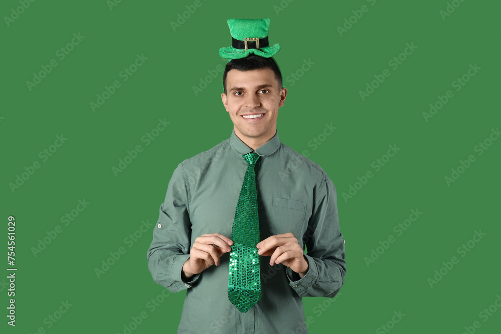 Happy young man on green background. St. Patrick's Day