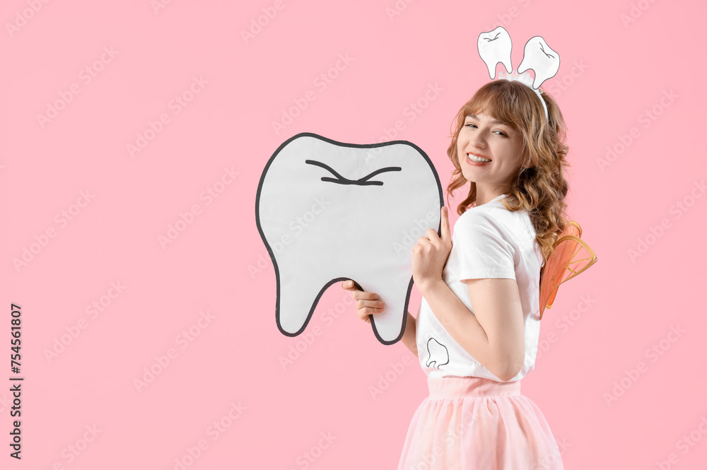 Tooth Fairy with paper figure on pink background
