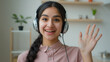 © Yuliia - Webcam view Arabian woman smiling girl blogger businesswoman internet tutor business coach in headphones talk to camera greet video meeting call online webinar lesson young student distant education
