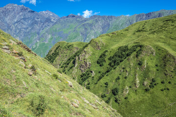 Wall Mural - View from path from Stepantsminda town and Gergeti village to Gergeti Holy Trinity Church in Caucasus Mountains, Georgia. Mount Shani on left side