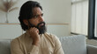 © Yuliia - Thoughtful man Arabian muslim guy think idea indian male homeowner looking away dreaming thinking deep thought solve problem consider decide brainstorming at home pensive businessman ponder solution