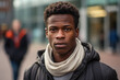 Black Man in his 20s or 30s talking head shoulders shot bokeh out of focus background on a cosmopolitan western street vox pop website review or questionnaire candid photo