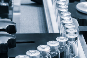 Poster - Pharmaceutical industry. Production line machine conveyor with glass bottles ampoules at factory. Pharmaceutical industry concept background.