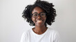 © Studio Nova - young woman with curly hair and glasses is smiling directly at the camera against a plain white background.