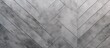 © Lasvu - The image shows a gray and white tiled wall with a diagonal pattern, creating a modern and structured design. The wall is made of ceramic tiles with a concrete stone surface background,